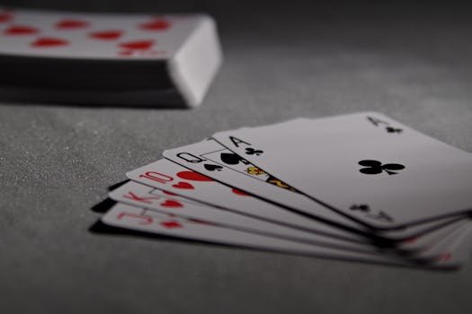 pexels photo 279009 279009 1 Detailed view of playing cards displaying a winning poker hand in a dimly lit scene.