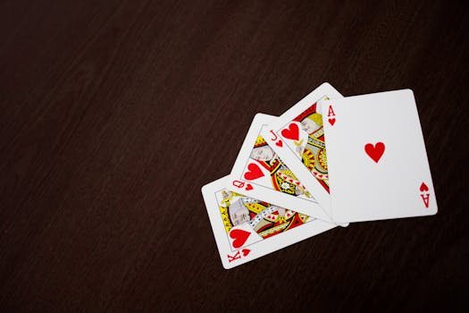 pexels photo 297507 297507 Elegant flat lay of playing cards featuring ace of hearts on a wooden surface.